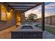 The backyard features a covered pergola, a hot tub, and a pool providing a perfect space for outdoor relaxation and entertainment at 11274 Felice Cohn Ct, Las Vegas, NV 89179