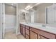 Bathroom featuring double sinks, wood cabinets, and a shower/tub combo at 11274 Felice Cohn Ct, Las Vegas, NV 89179