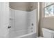 Bright, neutral bathroom with a white shower-tub combo and toilet at 11274 Felice Cohn Ct, Las Vegas, NV 89179