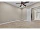 Neutral bedroom with carpet, ceiling fan, and an open door leading to a walk-in closet at 11274 Felice Cohn Ct, Las Vegas, NV 89179