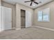 Neutral bedroom featuring a fan, closet, and a window at 11274 Felice Cohn Ct, Las Vegas, NV 89179