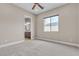 Neutral bedroom with a ceiling fan, window with blinds, and ensuite bath at 11274 Felice Cohn Ct, Las Vegas, NV 89179