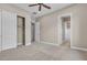 Neutral bedroom features a ceiling fan, closet and attached bathroom at 11274 Felice Cohn Ct, Las Vegas, NV 89179