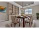 Elegant dining room featuring a modern light fixture, stylish decor, and a built-in display cabinet at 11274 Felice Cohn Ct, Las Vegas, NV 89179