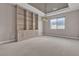 Versatile empty room with neutral decor, a built-in shelving unit, and a modern light fixture at 11274 Felice Cohn Ct, Las Vegas, NV 89179