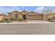 Inviting single-story home with a well-manicured front yard and a paver driveway leading to a three-car garage at 11274 Felice Cohn Ct, Las Vegas, NV 89179