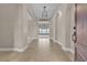 Grand foyer with an elegant chandelier, arched doorways, and tile flooring leading to the main living areas at 11274 Felice Cohn Ct, Las Vegas, NV 89179