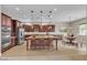 Brightly staged kitchen with a granite island, stainless appliances, a cozy dining area, and views to the lush backyard at 11274 Felice Cohn Ct, Las Vegas, NV 89179