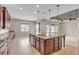 Bright open kitchen with tile flooring, a large island with granite countertops, and stainless steel appliances at 11274 Felice Cohn Ct, Las Vegas, NV 89179