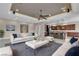 Open-concept living room showcasing modern furnishings and decor, plus an adjacent kitchen with a breakfast bar at 11274 Felice Cohn Ct, Las Vegas, NV 89179