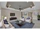 Staged living room features a modern ceiling, ceiling fan, sofa, chairs, TV, and stylish decor at 11274 Felice Cohn Ct, Las Vegas, NV 89179