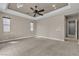 Large primary bedroom with a tray ceiling, recessed lighting, and three large windows at 11274 Felice Cohn Ct, Las Vegas, NV 89179