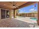 Covered patio with ceiling fan, sliding glass door and a pool beyond at 11274 Felice Cohn Ct, Las Vegas, NV 89179