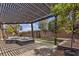Inviting outdoor space showcasing a pergola with pavers, lush greenery, and a tranquil spa at 11274 Felice Cohn Ct, Las Vegas, NV 89179