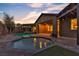 Stunning backyard pool and spa featuring brick pavers and a covered patio, perfect for outdoor entertaining at 11274 Felice Cohn Ct, Las Vegas, NV 89179