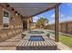 Backyard with a luxurious spa under a pergola, accented by a pool and meticulously designed pavers at 11274 Felice Cohn Ct, Las Vegas, NV 89179