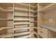 Organized walk-in closet featuring custom shelving and drawers, maximizing storage and creating easy access to your wardrobe at 11274 Felice Cohn Ct, Las Vegas, NV 89179