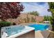 Inviting backyard featuring a luxurious hot tub spa next to a sparkling swimming pool and mature trees at 11342 Early Sun Ct, Las Vegas, NV 89135