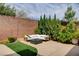 Cozy backyard lounge area with a stylish sofa and modern fire pit at 11342 Early Sun Ct, Las Vegas, NV 89135
