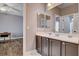 This bathroom features a double sink vanity with dark wood cabinets at 11342 Early Sun Ct, Las Vegas, NV 89135