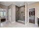 Spacious bathroom featuring a large walk-in shower with gray tile and a walk-in closet at 11342 Early Sun Ct, Las Vegas, NV 89135
