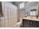 Cozy bathroom featuring a shower with a curtain, toilet, and vanity with ample storage space at 11342 Early Sun Ct, Las Vegas, NV 89135