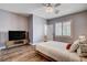 Modern bedroom with wood floors, a platform bed, TV, and a view of the plantation shutters at 11342 Early Sun Ct, Las Vegas, NV 89135