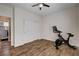 Bedroom boasts hardwood floors, ceiling fan, closet with large doors, and exercise equipment at 11342 Early Sun Ct, Las Vegas, NV 89135