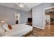 Comfortable bedroom with wood floors, a platform bed, ceiling fan, and a glimpse into the bathroom at 11342 Early Sun Ct, Las Vegas, NV 89135