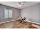 This well-lit bedroom features wood-look floors and a ceiling fan with light at 11342 Early Sun Ct, Las Vegas, NV 89135