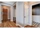Hallway featuring hardwood floors, neutral walls, and access to a bathroom with decorative floor tiles at 11342 Early Sun Ct, Las Vegas, NV 89135