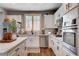 Well-appointed kitchen featuring white cabinets, stainless steel appliances, and a center island with elegant countertops at 11342 Early Sun Ct, Las Vegas, NV 89135