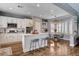 Bright kitchen boasts white cabinetry, stainless appliances, center island, and an adjacent dining area with bay windows at 11342 Early Sun Ct, Las Vegas, NV 89135