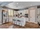 Modern kitchen featuring stainless steel appliances, a center island with seating, and a convenient pantry at 11342 Early Sun Ct, Las Vegas, NV 89135