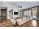 Spacious living room with built-in shelves, a comfortable sofa, and access to the backyard pool at 11342 Early Sun Ct, Las Vegas, NV 89135