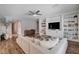 Inviting living room featuring built-in shelving, a ceiling fan, and comfortable seating at 11342 Early Sun Ct, Las Vegas, NV 89135