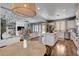 Open-concept kitchen and living space with white cabinets and lots of natural light at 11342 Early Sun Ct, Las Vegas, NV 89135