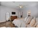 Comfortable main bedroom with wood floors, neutral decor, ensuite bathroom, and a ceiling fan at 11342 Early Sun Ct, Las Vegas, NV 89135