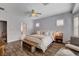 Relaxing main bedroom featuring wood floors, neutral decor, and an abundance of natural light through shuttered windows at 11342 Early Sun Ct, Las Vegas, NV 89135