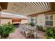 Covered patio with a dining table, swing, string lights, and decorative plants, perfect for entertaining at 11342 Early Sun Ct, Las Vegas, NV 89135