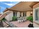 Inviting outdoor patio with a dining table, charming string lights, and shaded seating area at 11342 Early Sun Ct, Las Vegas, NV 89135