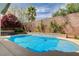 Beautiful backyard pool area with spa, water feature, privacy wall, and mature landscaping at 11342 Early Sun Ct, Las Vegas, NV 89135