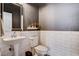 This powder room features an ornate pedestal sink, white subway tile, and patterned floors at 11342 Early Sun Ct, Las Vegas, NV 89135