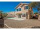 Backyard with mature trees, rock landscaping, and sparkling blue pool at 124 Countrywood Cir, Las Vegas, NV 89107