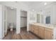 Updated bathroom with a double vanity, wood-style flooring and closet in the Primary suite at 124 Countrywood Cir, Las Vegas, NV 89107