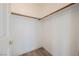 Walk-in closet features a wood closet rod, white paint, and wood-style flooring at 124 Countrywood Cir, Las Vegas, NV 89107
