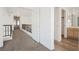 Upstairs hallway with black metal railing, wood floors and neutral paint at 124 Countrywood Cir, Las Vegas, NV 89107