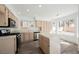 Well-lit kitchen featuring stainless steel appliances, an island, and plenty of cabinet space for storage at 124 Countrywood Cir, Las Vegas, NV 89107