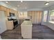 Charming kitchen with stainless steel appliances, ample counter space, an island, and wood-look flooring at 124 Countrywood Cir, Las Vegas, NV 89107