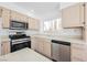 Bright and spacious kitchen featuring stainless steel appliances, ample counter space, and neutral cabinetry at 124 Countrywood Cir, Las Vegas, NV 89107